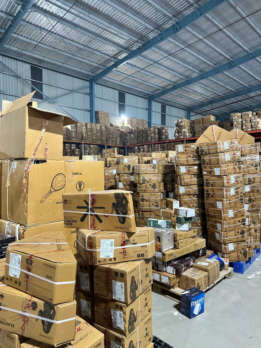 View of high-stack cartons and storage density inside the central home appliance warehouse in Panipat